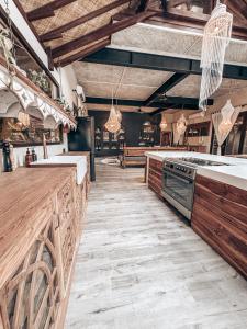 a large kitchen with wooden counters and a stove at Casa Magick boutique Villa in Gili Islands