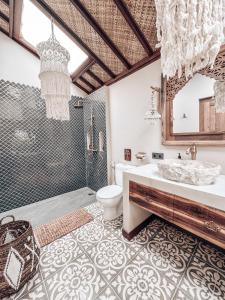 a bathroom with a tub and a toilet and a sink at Casa Magick boutique Villa in Gili Islands +32 photos