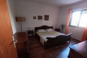 a bedroom with a bed and a window at Seaside holiday house Jezera, Murter - 23324 in Jezera