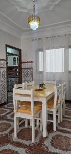 a dining room with a white table and chairs at Dar Tetuan 4 You III in Tétouan