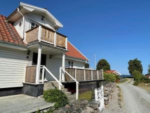 a house with a deck on the side of it at 4 star holiday home in SÖLVESBORG in Sölvesborg