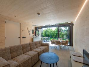 a living room with a couch and a table at Luxury holiday home by the sea in Sint Maartenszee