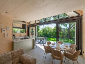 a kitchen and dining room with a table and chairs at Luxury holiday home by the sea in Sint Maartenszee