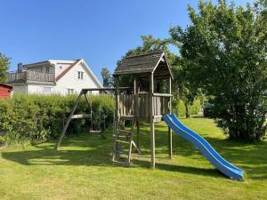 a playground with a slide in a yard at 4 star holiday home in SÖLVESBORG in Sölvesborg