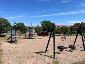an empty playground with two swings at 4 person holiday home in SENOREN in Möcklö