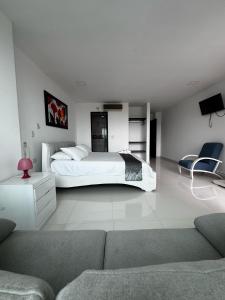 a white bedroom with a bed and a couch at Scherezade Hotel&Resorts in Aguachica +38 photos