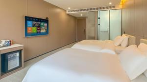 Voodi või voodid majutusasutuse 云泊夜酒店浦东机场店Yunboye Hotel Shanghai Pudong Airport Branch toas