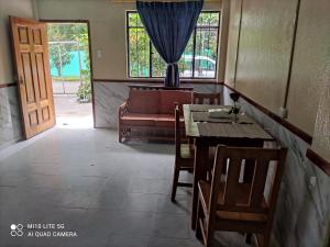 a living room with a table and chairs and a couch at Residencia abuelita Carmen in Mindo +27 photos