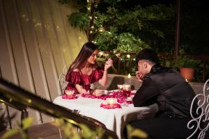 a man and a woman sitting at a table at Visamo Nalsarovar Resort, Ahmedabad in Bavla