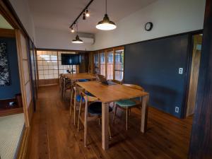 a dining room with tables and a laptop on it at OMISIHMA SPACE Hanare in Kamiura