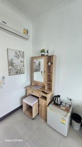 a kitchen with a counter and a refrigerator in a room at Passion Nai Harn Guesthouse in Nai Harn Beach