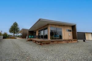 a house with a large glass window on the side of it at Starlight Townhouse in Twizel