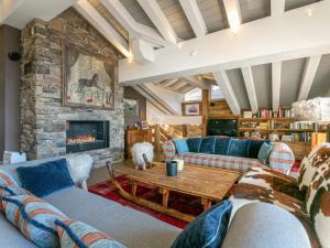 a living room with couches and a stone fireplace at Penthouse de Prestige au Cœur de Val-d'Isère, 5 Ch, Wifi - FR-1-694-430 in Val dʼIsère