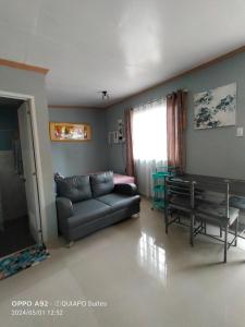 a living room with a couch and a table at BOHOL Simple and Elegant Furnished Studio in Tagbilaran City