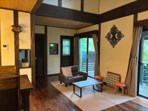 a living room with a couch and a table at Villa Grace in Hokuto