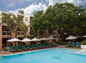 a hotel with a swimming pool with chairs and umbrellas at Henann Regency Resort and Spa in Boracay