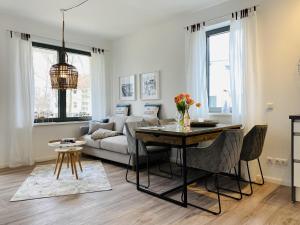 a living room with a couch and a table at Ferienwohnung Ostseeliebe Parkvillen Carlota und Candela Baabe in Baabe
