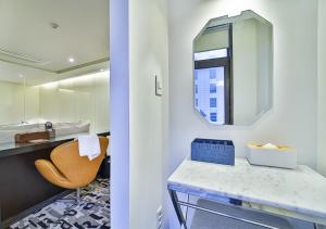 a bathroom with a sink and a mirror and a chair at js 부티크 호텔 동탄 in Hwaseong +158 photos