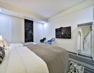 Ένα ή περισσότερα κρεβάτια σε δωμάτιο στο JS Boutique Hotel