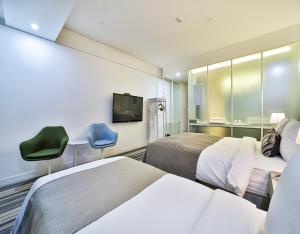 Ένα ή περισσότερα κρεβάτια σε δωμάτιο στο JS Boutique Hotel