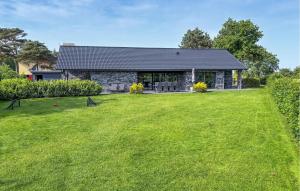 a house with a large lawn in front of it at Amazing Home In Grenaa With Wifi in Grenå