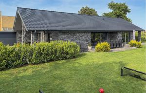 a house with a yard in front of it at Amazing Home In Grenaa With Wifi in Grenå +26 photos