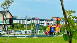 a playground in a park in front of a building at Warm & Cozy Home in Kampong Duson Gilap