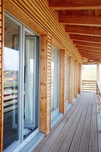 a porch of a wooden house with windows at Gästehaus am Landgut in Schönwalde