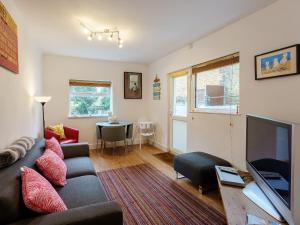 a living room with a couch and a television at Fisherman's Rest in Broadstairs