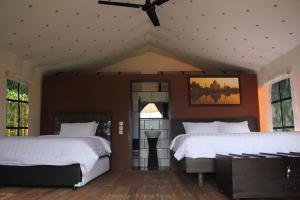 a bedroom with two beds and a ceiling fan at Trizara Resorts - Glam Camping in Lembang