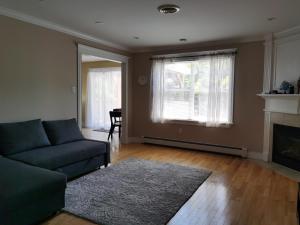 a living room with a couch and a fireplace at Breeze Inn #3 in Halifax