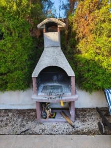 an outdoor pizza oven sitting on the ground at Villa Arfa in Peyia