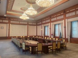 a large conference room with a long table and chairs at Jahamun Hotel in Seoul