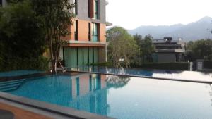 a large swimming pool in front of a building at Panorama view of the world in Phayayen