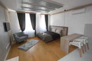 a bedroom with a bed and a table and a couch at New Belgrade Apartments Magnetic, parking 5 evra dan in Belgrade