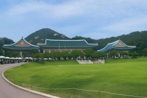 a building with a green field in front of it at Jahamun Hotel in Seoul