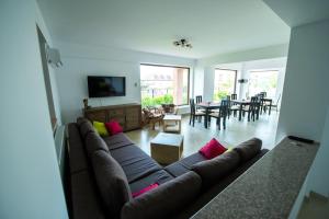 a living room with a couch and a dining room at Elina in Techirghiol
