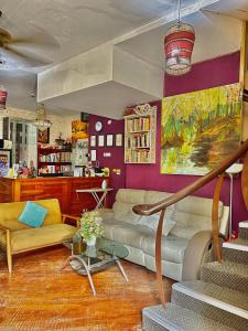 a living room with a couch and a table at The Explorers Guesthouse and Hostel in Kuala Lumpur