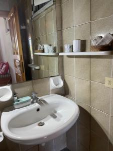a bathroom with a white sink and a mirror at casa l'olivo in Forio d'Ischia