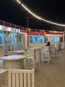 a row of tables and chairs on a patio at night at Baku, Seabreeze, Park Residence 2 in Baku +31 photos