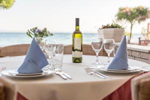 a table with a bottle of wine and glasses at Villa Amigo in Podstrana