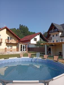a swimming pool in the backyard of a house at Casa Mathias in Buşteni