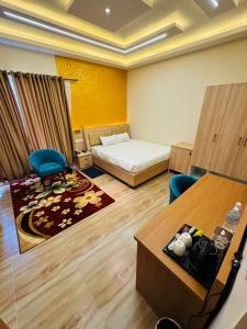 a hotel room with a bed and a table and chairs at Kwality Beach Resort in Beni Ghāt