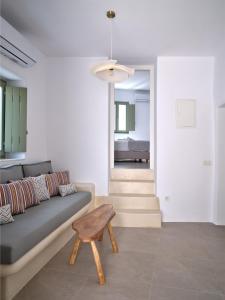a living room with a couch and a stool at Este Naousa in Naousa