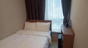 Uma cama ou camas num quarto em WE Hotel Kowloon