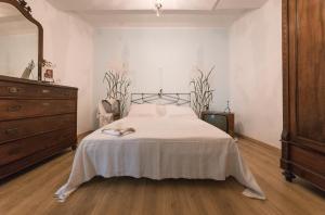 a bedroom with a large bed and a dresser at Da Rita in San Terenzo