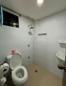 a bathroom with a toilet and a sink at Apartment MJ in Olongapo +22 photos