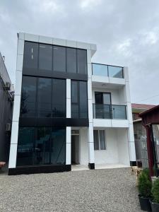 a modern house with black and white at Saba Guest House in Ureki