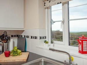 a kitchen with a sink and a window at The White House in Poundstock +20 photos