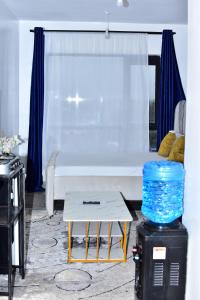 a living room with a white couch and a table at Savannah Suites Nairobi in Nairobi
